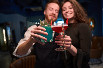 Young Caucasian couple enjoying cocktails at dimly lit bar © Svitlana