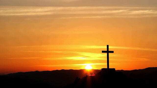A serene cross silhouette stands against a vibrant orange sunset sky