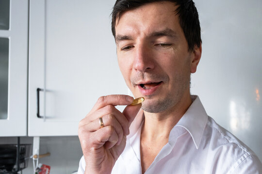 Taking supplement for men's immunity and energy, vitamins for sport, focus, testosterone support, wellness ad, brand promotion for men