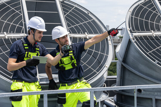 Professional Worker Teamwork Servicing HVAC building cooling tower, Industry air conditioner service