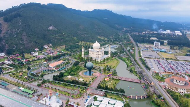 The aerial perspective showcases Jaime Duque Park, highlighted by a large monument and lush green surroundings under a cloudy sky.