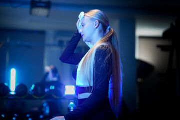 Blonde woman closing eyes to focus on breathing and mind muscle connection. Promoting mental...