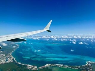 Window view of airplane wing above Mexican coastline including Cancun hotel zone and Isla Mujeres in Quintana Roo, Yucatan Peninsula, Mexico © Milena