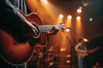 Obraz premium Musician Strumming Polished Acoustic Guitar During Live Stage Performance with Softly Blurred Singer