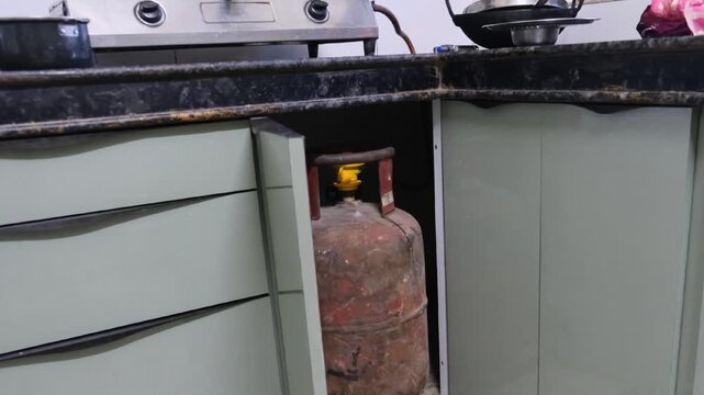 LPG gas cylinder kept inside modular kitchen cabinet