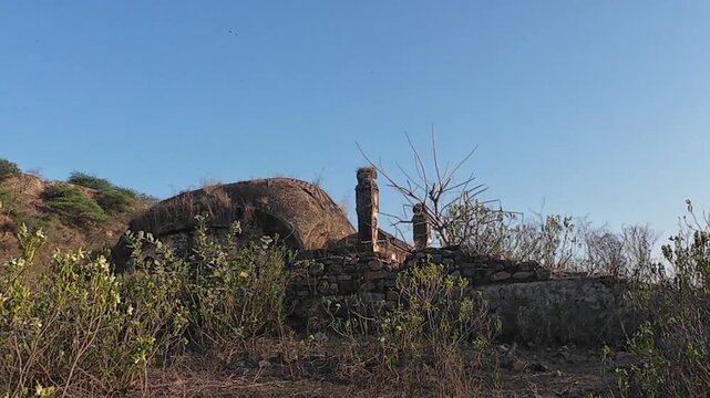 The abandoned and neglected ruins of the 15th-century Indore Fort located on a rocky ridge in the Mewat region of Haryana, India