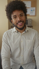 Fototapeta premium Man smiling in an office environment, showcasing a professional setting with business attire and friendly demeanor, reflecting a casual workplace atmosphere.