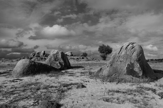 Exposed Granite Boulders on Dry Lakebed at Folsom Lake California. Dramatic clouds hang over the drought-affected reservoir landscape in Northern California. Folsom Lake, Folsom California, 