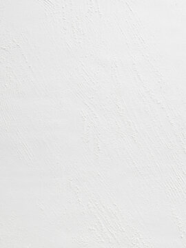 The image shows a white textured wall with subtle patterns. This can be used for interior design projects, home decor inspiration, or in advertising for construction materials