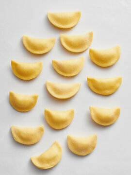 The image showcases a neat arrangement of homemade dumplings on a flat surface. Ideal for food blogs, restaurant menus, and cooking tutorials