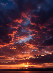 Obraz premium vibrant sunset painting the sky with intense shades of red and orange above a dark horizon line