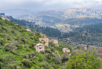 Naklejka premium Abandoned village of Lifta near Jerusalem in early spring, old stone houses on a green mountain slope.Israel.