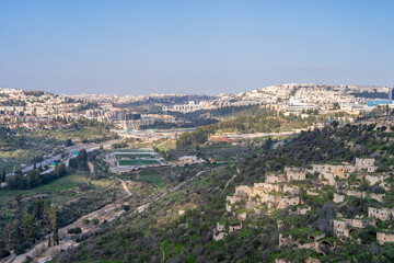 Panoramic view of Jerusalem neighborhoods, with the abandoned village of Lifta in the foreground, located on the slope of green hills in early spring.Israel.