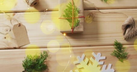 Fototapeta premium Displaying kraft-wrapped gift sitting on tabletop with twine spool, gift tag, snowflake, copy space