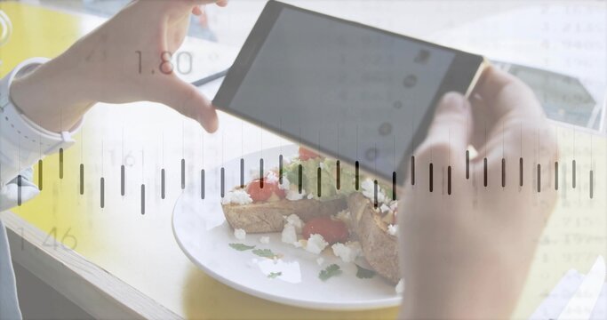 Holding phone, hands with white cuff watch framing food on yellow table, tomato-feta toast overlay
