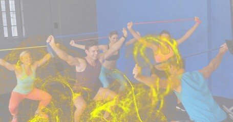 Stretching five adults squatting with resistance bands overhead in studio, wearing sportswear