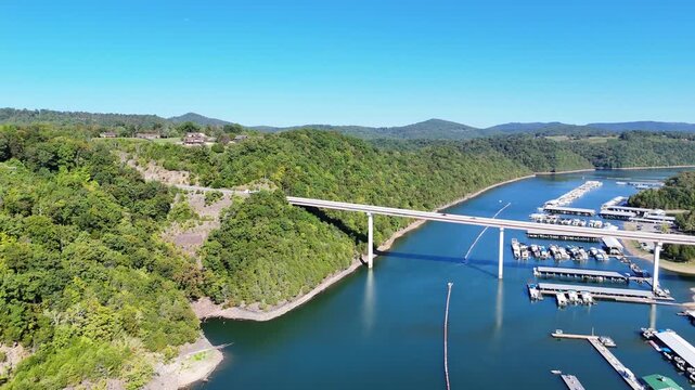 Aerial View of the Lakeside Sunset Marina Resort on Dale Hollow Lake With Highway 111 Bridge, Boats and Forested Shoreline, Calm Water on a Sunny Day, Monroe, Tennessee, USA.