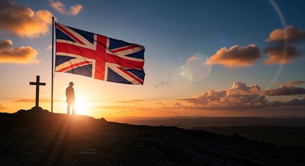 Cinematic sunset landscape silhouette on a hill beside cross, Union Jack flag, Anzac day, memorial or patriotism