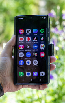 Menden, NRW, Germany &ndash; October 29, 2025 Hand holding a smartphone displaying various social media and AI application icons