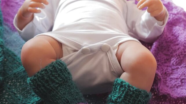 A doll lying on a colorful blanket, perfect for children's play or photography props