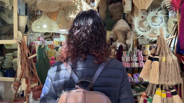 Woman shopping for handicrafts in moroccan souk market