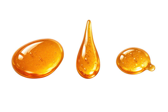 Three golden honey drops or syrup puddles isolated on a clean white background, showcasing a glossy, viscous texture perfect for food, cosmetic, or health-related designs.