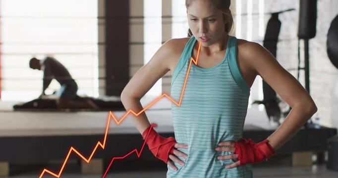 Woman athlete breathing red wraps as lower-left graphs appearing across torso, driving boxing focus
