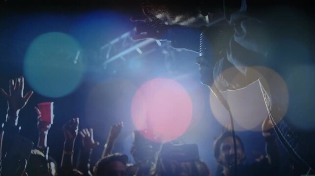 Vocalist leaning from concert stage reaching mic, cable, phones up, red cup up, flares drifting