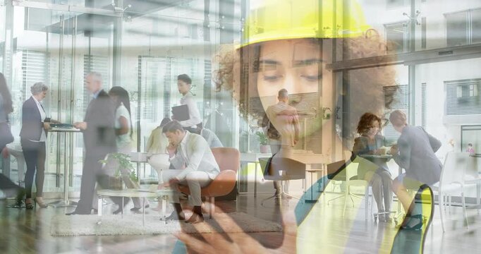 Woman in yellow hard hat tapping device starting crossfade overlaying business lobby updating data