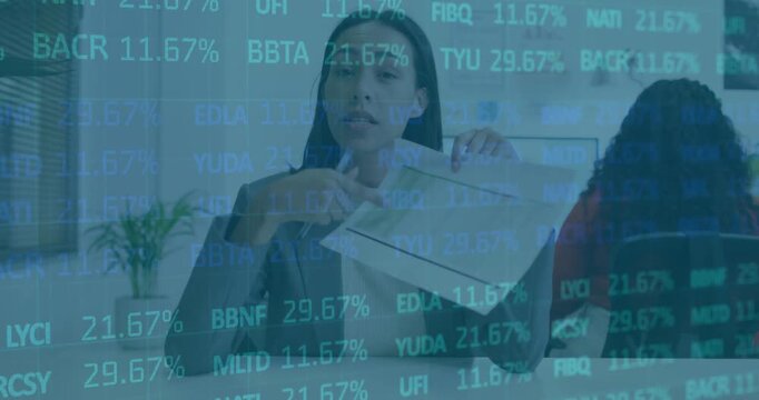 Woman glancing reaching envelope unfolding paper showing finance with stock overlay tinting frame