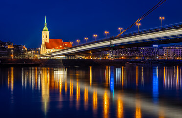 Fototapeta premium Bratislava night skyline with St Martins Cathedral bridge and reflections
