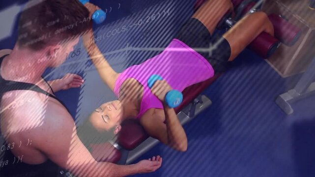 Woman lying on decline bench doing chest fly for fitness spotter aiding with DBs overlay tracing