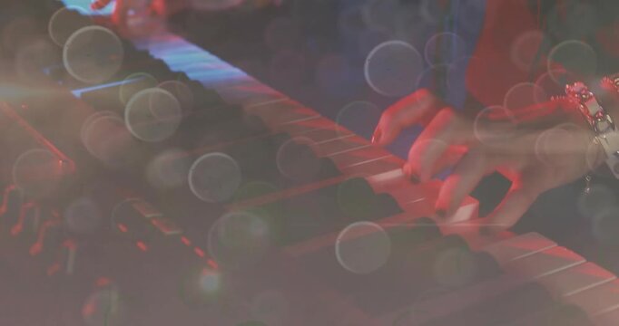 Vertical video: Playing after cue player hands rolling across synth for set, dark top, watch, bokeh