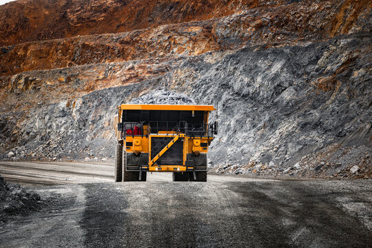 Open pit mine industry, big yellow mining truck for gold ore