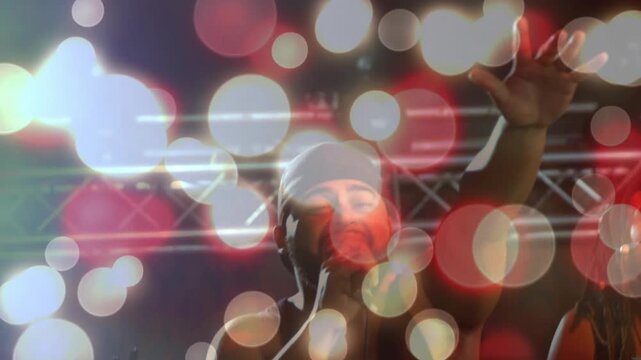 Camera zooming, showing singer singing on mic on music stage while bokeh centering singer for crowd