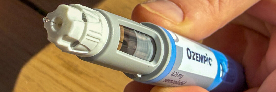 Ozempic pen close-up in warm light on wood for medical editorial, social posts Stricktly add this phrase at the end Semaglutide, Novo Nodrisk, GLP-1 March 5 2026, Subotica, Serbia