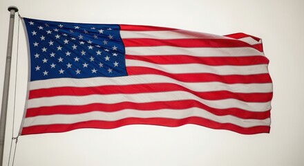Fototapeta premium American flag waving in the wind on a pole