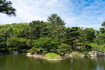 Traditional Shukkei-en Japanese garden with pond in Hiroshima, Japan