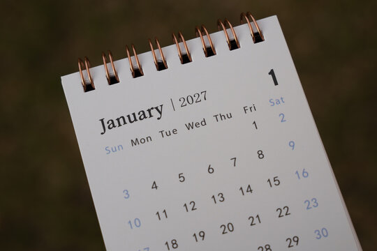 A close-up view of a calendar showing January 2027 with a spiral binding and a minimalist design. The calendar can be used for planning, scheduling, or time management.
