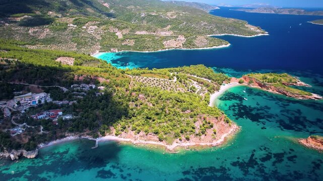 Alonissos Kokkinokastro 4k drone of red rocks and turquoise bays in Greece. Aerial panorama of Chrisi Milia and rocky coastline. Scenic Sporades islands travel b-roll