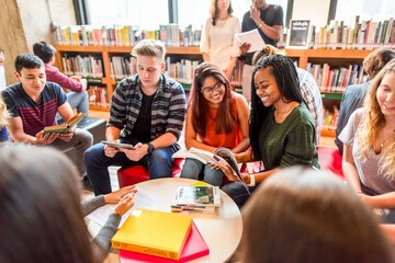 Diverse students studying in library.