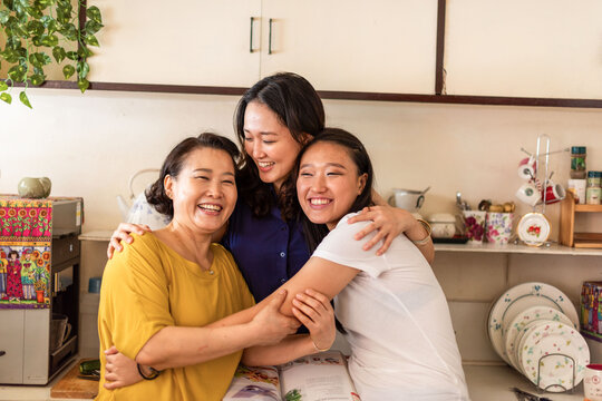 Joyful family kitchen embrace