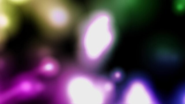 Vibrant lights blur against a dark background. Purple, green, and gold glow softly out of focus