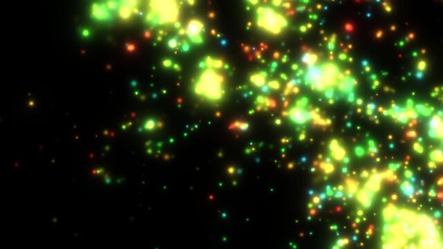 Bright green and yellow particles float in a dark void. Tiny glowing orbs drift randomly through the deep black