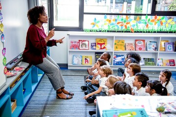 Teacher engaging children attentively.