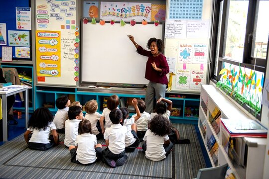 Teacher engaging young students creatively.