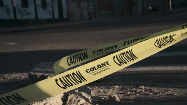 Slow motion shot of caution tape on a city street