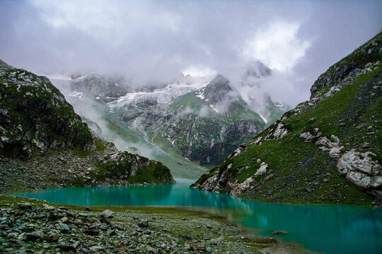 Serene Tulian Lake, Pahalgam, Kashmir Surrounded by Misty Mountains and Cloudy Sky