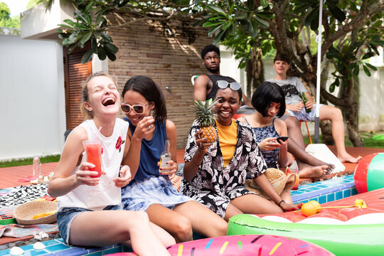 Friends enjoying summer poolside.