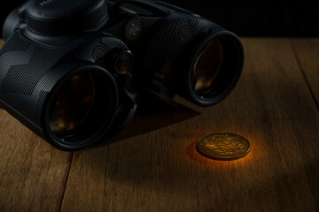 Binoculars with coin maritime adventure still life